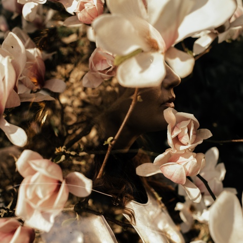 Sesja artystyczna portret kobiety z podwójnym naświetlaniem i tłem z kwitnących magnolii
